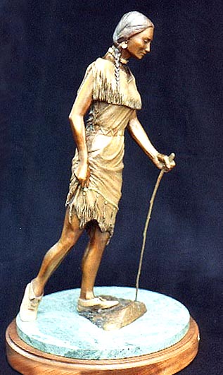 A Sioux maiden carefully crosses a stream at about the point in history of Europeans' first contact with them.  She wears a doeskin dress trimmed with quillwork and a precious steel  knife acquired from the white traders